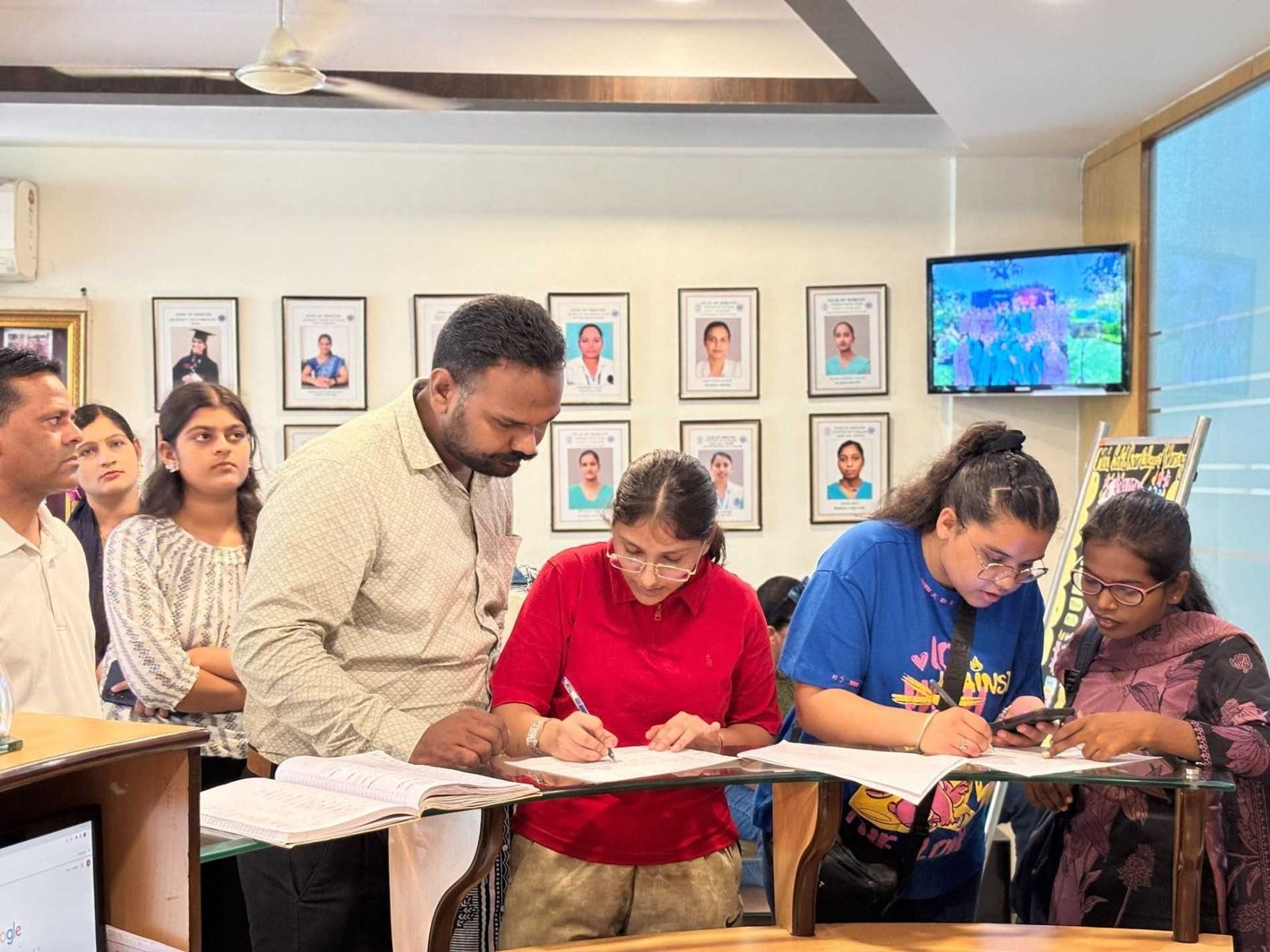 Students and parents filling registration forms at the reception desk on Orientation Day, MSK College of Nursing Mohali